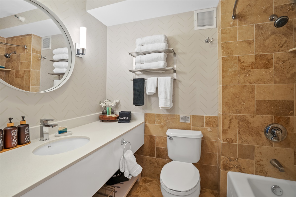 Bright, clean bathroom with shampoo, conditioner, and body wash included.