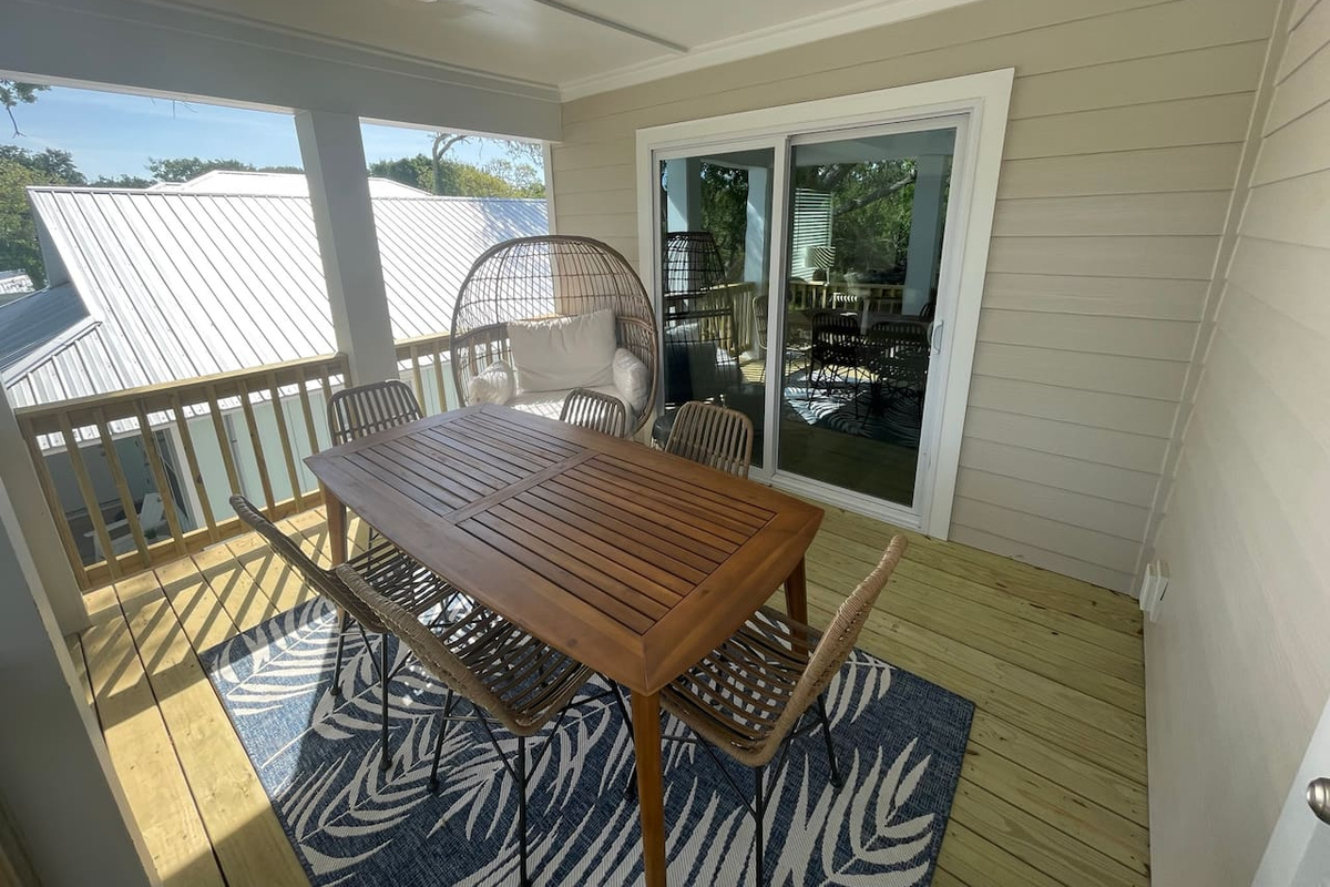 Breakfast tastes better in the treetops — the covered balcony seats six for meals in the open air, with a hanging egg chair for the early riser who claims the best seat, a paperback, and the first quiet hour of the day.