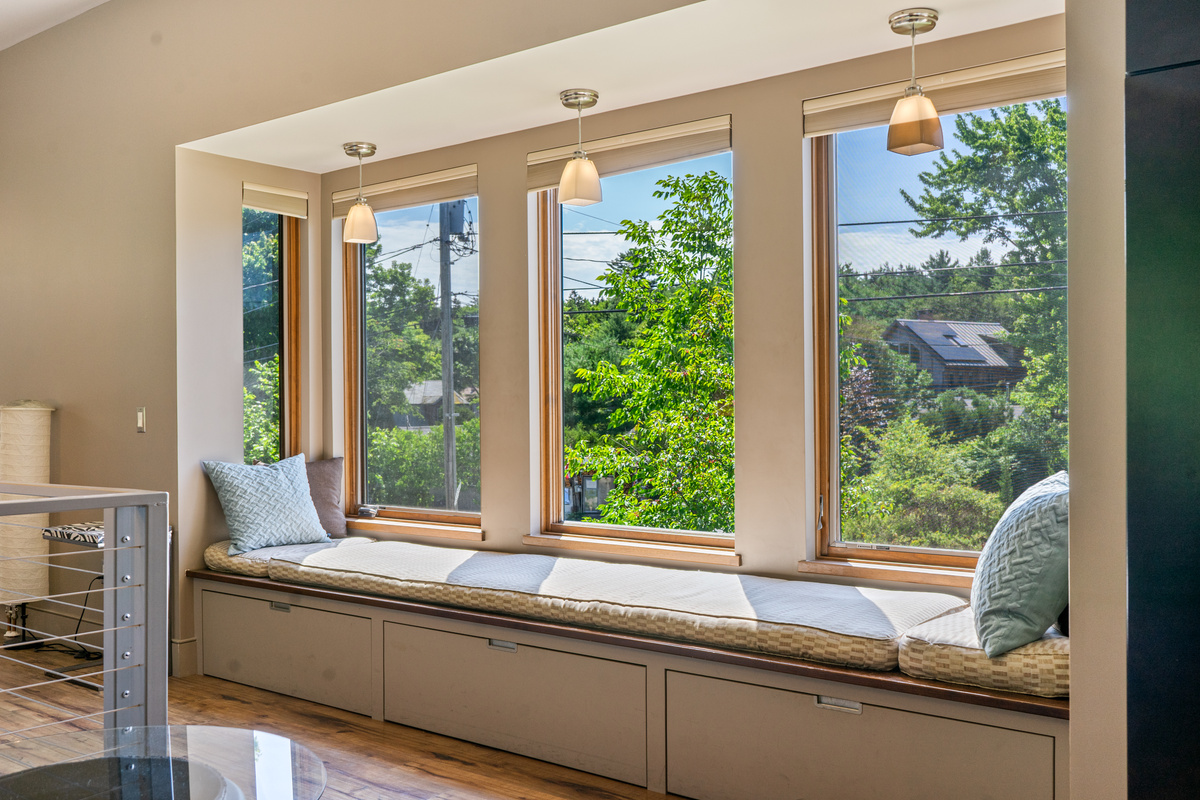 The ultimate reading nook at "The Crag." This cushioned built-in window seat features individual pendant lighting and panoramic views looking out over the village of Otter Creek—the perfect spot for morning coffee or afternoon relaxing.