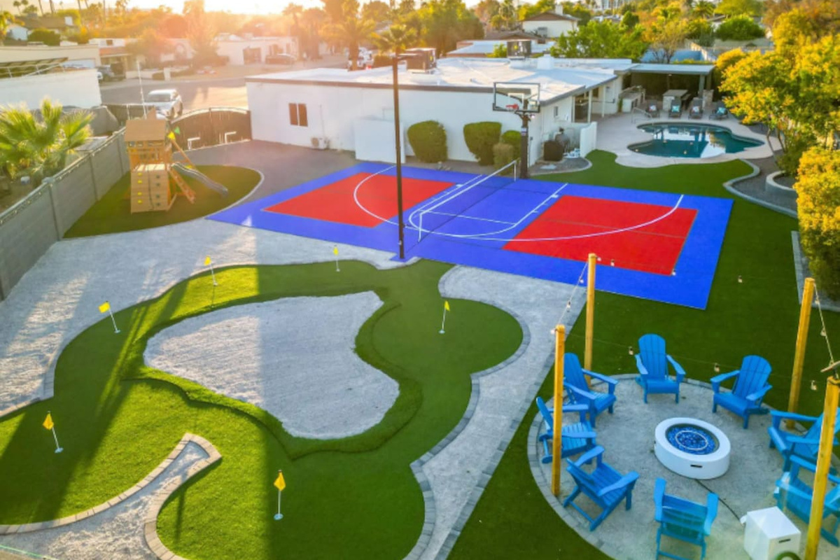 From above, the backyard reveals just how much this property has to offer: a full sport court, a putting course, and a fire pit lounge all within steps of each other.
