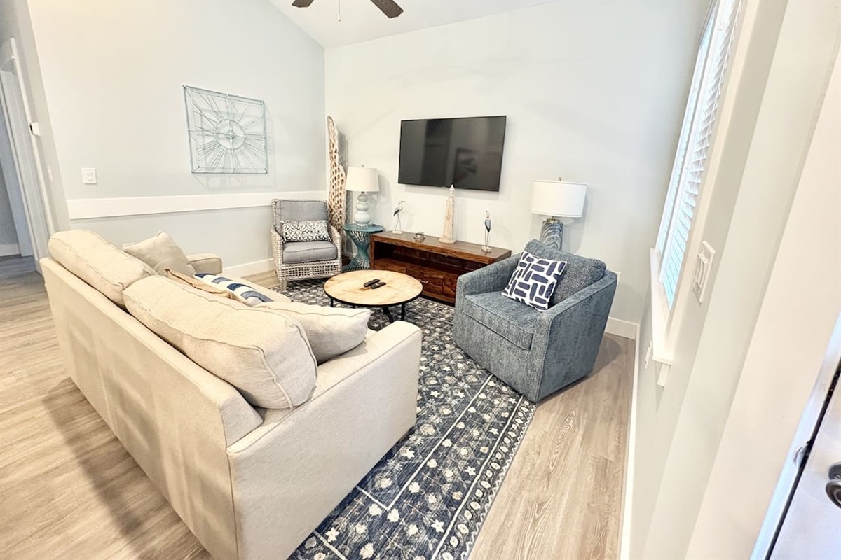 Comfortable living area featuring a queen-size sleeper sofa and smart TV