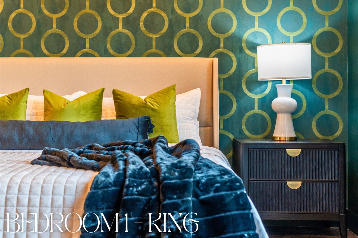 This king bedroom is a restful retreat with soft bedding and charming decor, offering a peaceful place to recharge after a day of adventure.