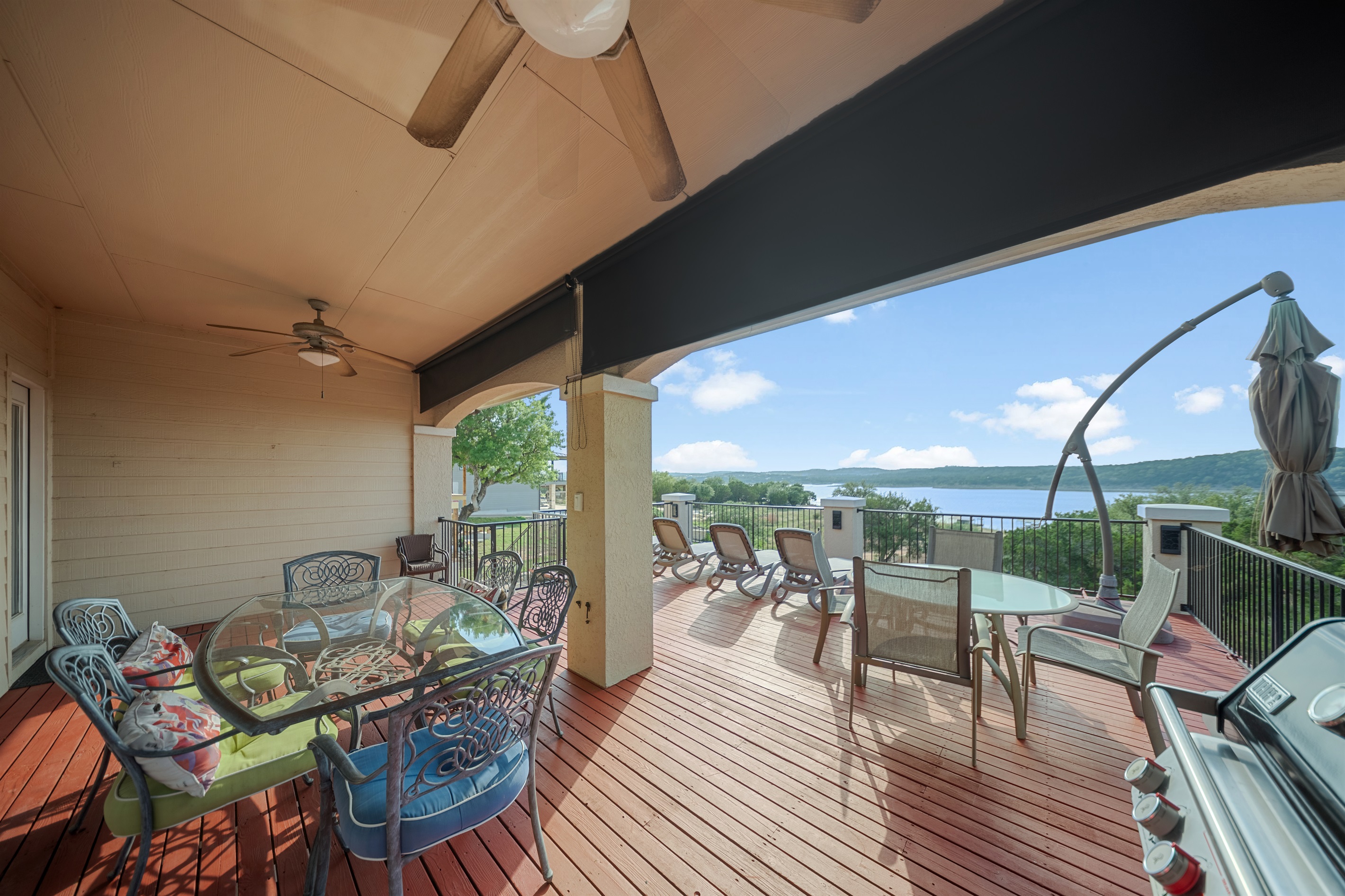 The upstairs balcony features a grill, ample outdoor seating, and lounge chairs. 