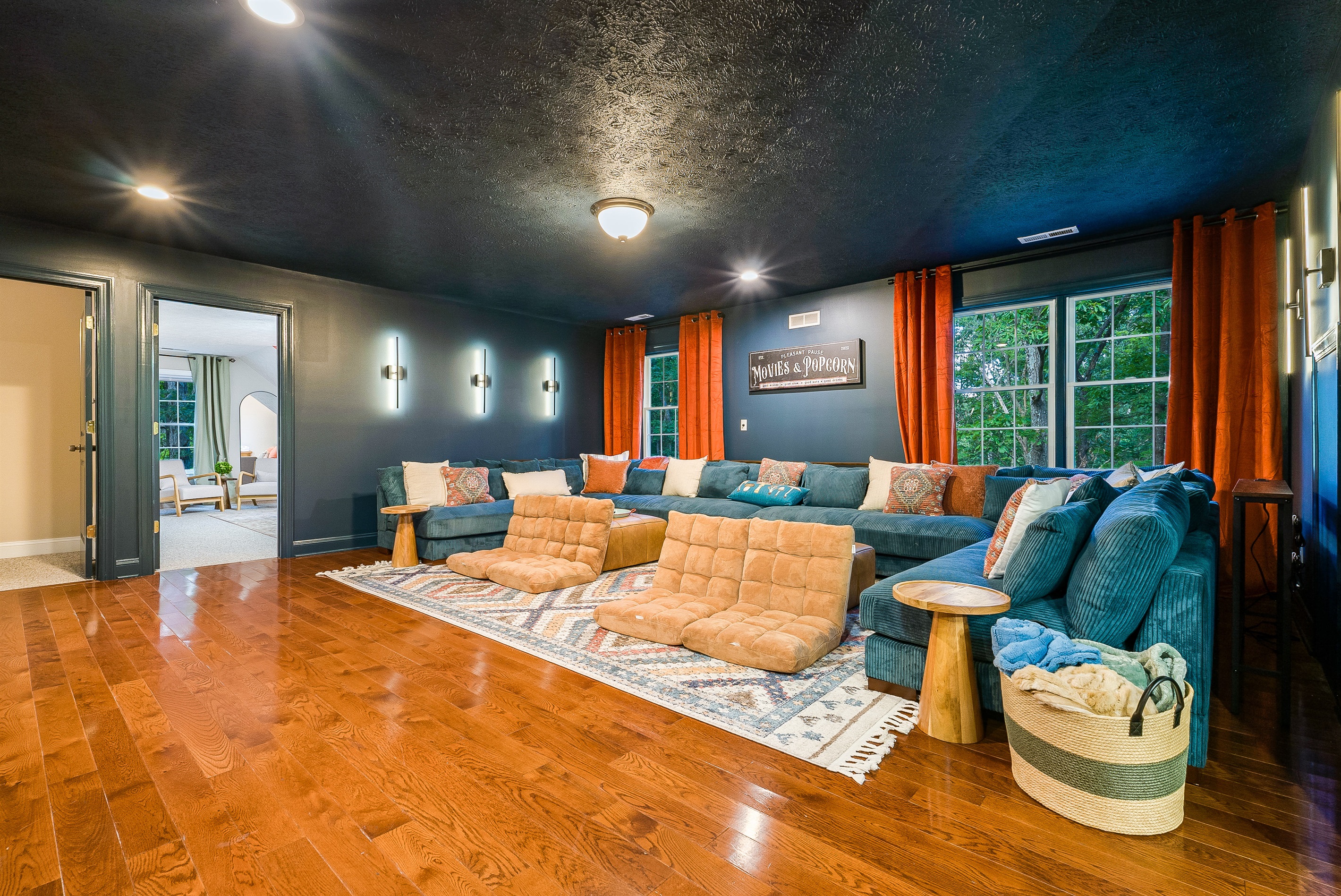 With oversized sectionals, floor cushions, and cinematic vibes, this movie room is designed for family nights that turn into lasting memories