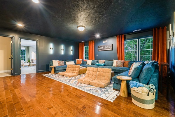 With oversized sectionals, floor cushions, and cinematic vibes, this movie room is designed for family nights that turn into lasting memories