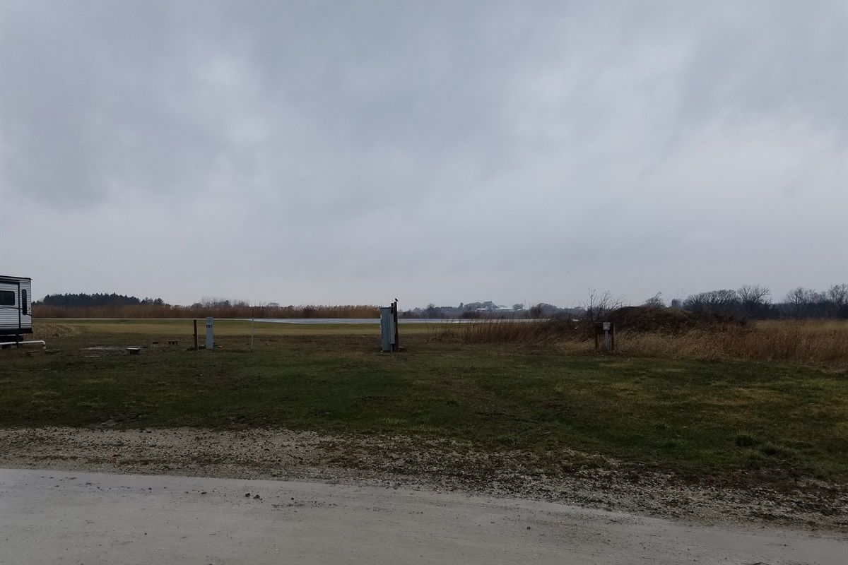Overlooking the runway from the deck you can see the planes land and skydivers depending upon the spot.  The view may change with campers and RV's filling the campground slots either permanently or for events.  Corn or beans crops may also change the view.