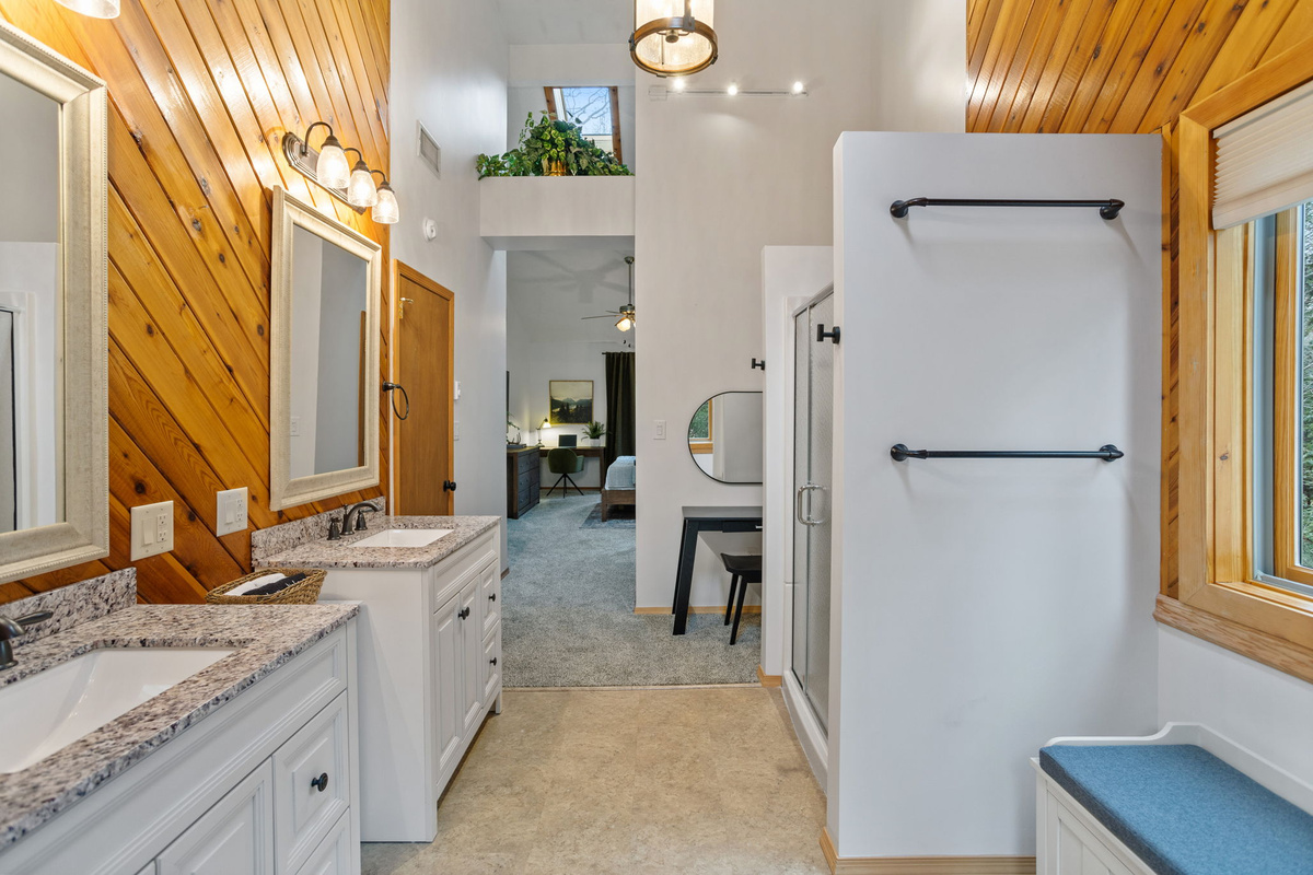 Imagine stepping into this master bathroom—It's a dream come true! With high ceilings that create an airy ambiance, stylish racks, and a cozy sitting bench.
