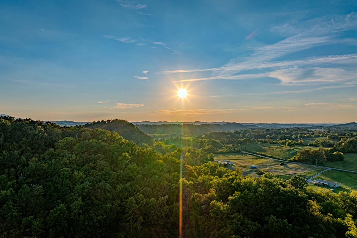 Golden Hour on the Horizon. The true beauty of the Smokies is revealed at sunset. This sweeping, high-altitude view captures the lush landscape that surrounds your unique glamping destination.