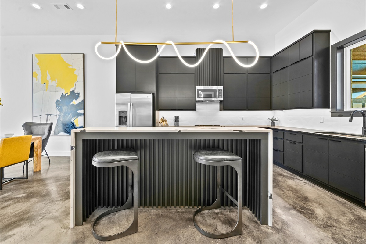 A beautifully crafted kitchen featuring high-end finishes, a functional island with seating, and clean lines that perfectly balance form and function.