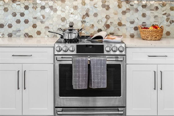 Elegant range and statement backsplash create a focal point