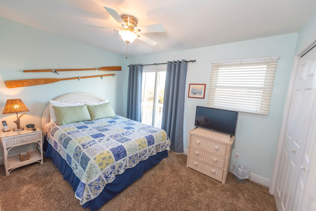 Sleep with the slider cracked and wake to Gulf air &mdash; your queen bedroom balcony is right there, private and facing the water.