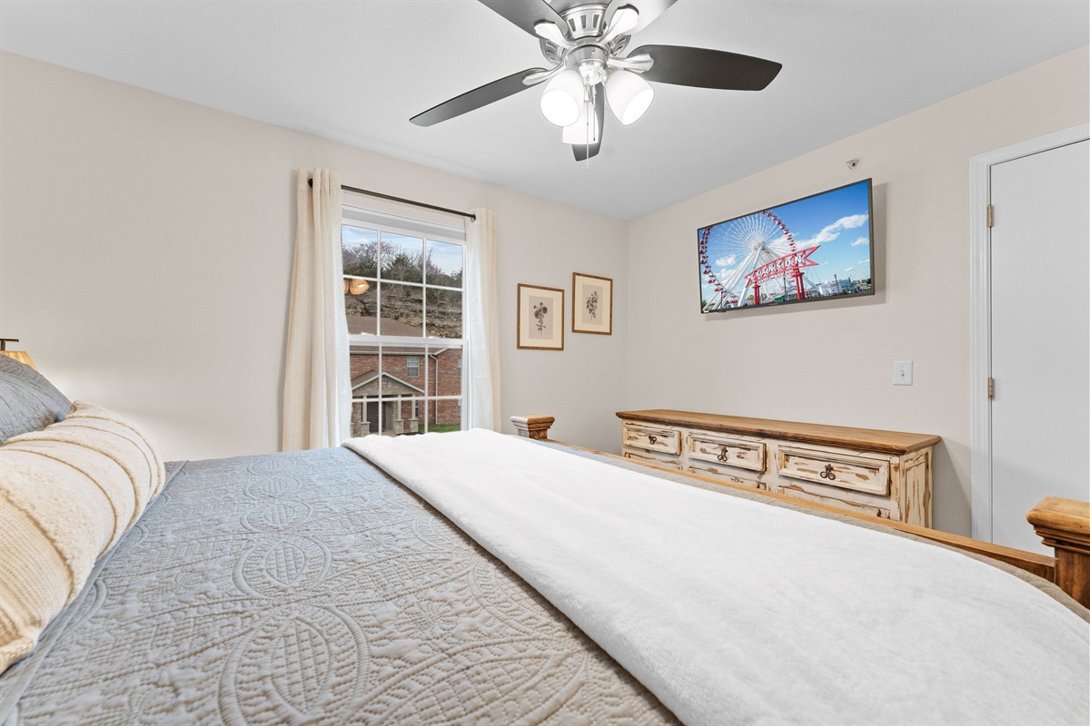 King bedroom with dresser and TV