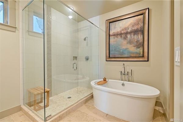 Master bathroom with a large walk-in shower and soaking tub.