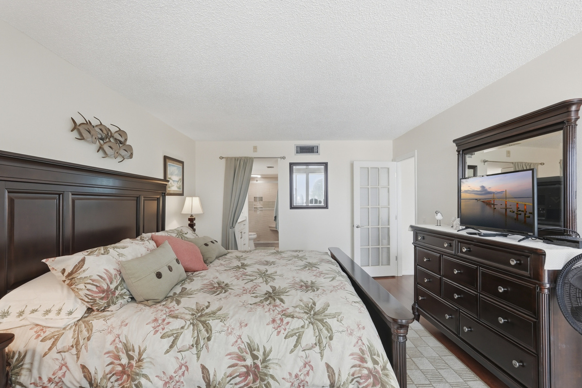 Settle into the comfort of the spacious main bedroom, featuring a king-size bed and a peaceful atmosphere designed for restful nights and easy mornings.