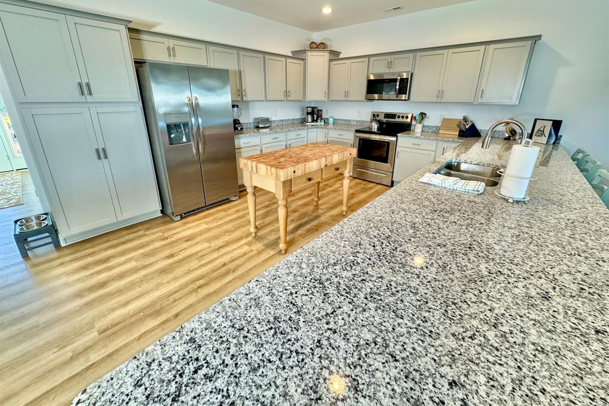 Enjoy cooking in this fully stocked kitchen with a custom island and ample bar seating. 