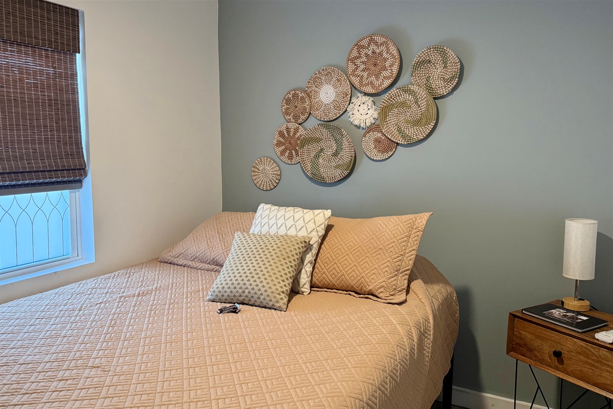 bedroom 1 with a queen size bed is just off the living room