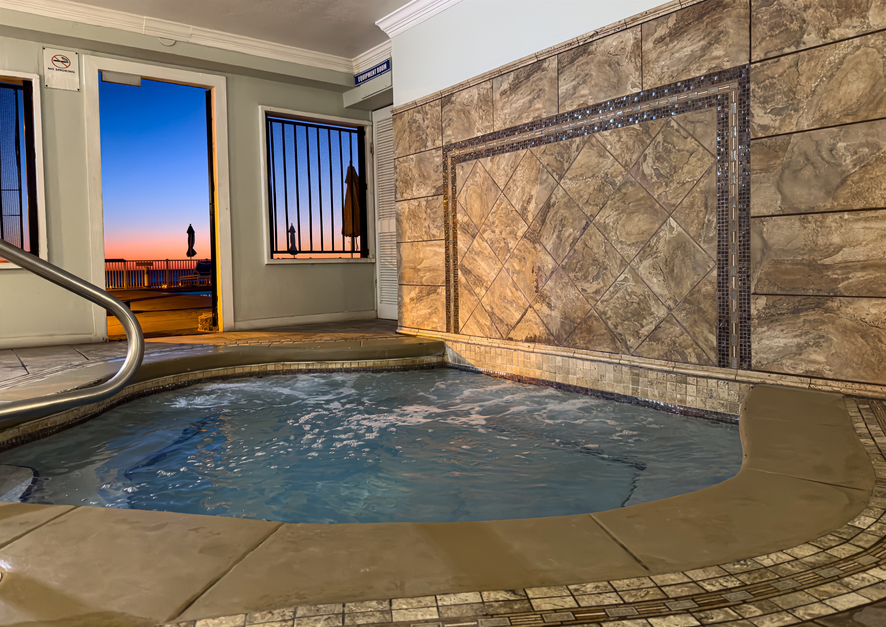This covered jacuzzi protects you from the wind while you soak. It is located right next to the main pool for easy access.