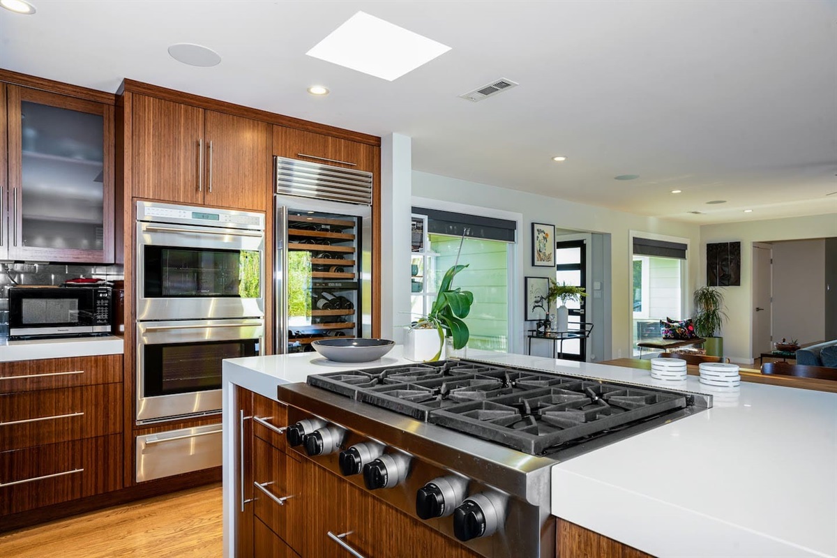 Fully stocked chef's kitchen with 8 person dining table and two person island seating.