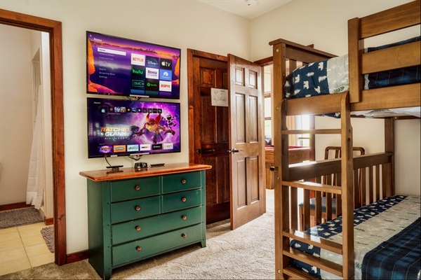 Fun bunk room with dual TVs and gaming setup—perfect for kids and teens.