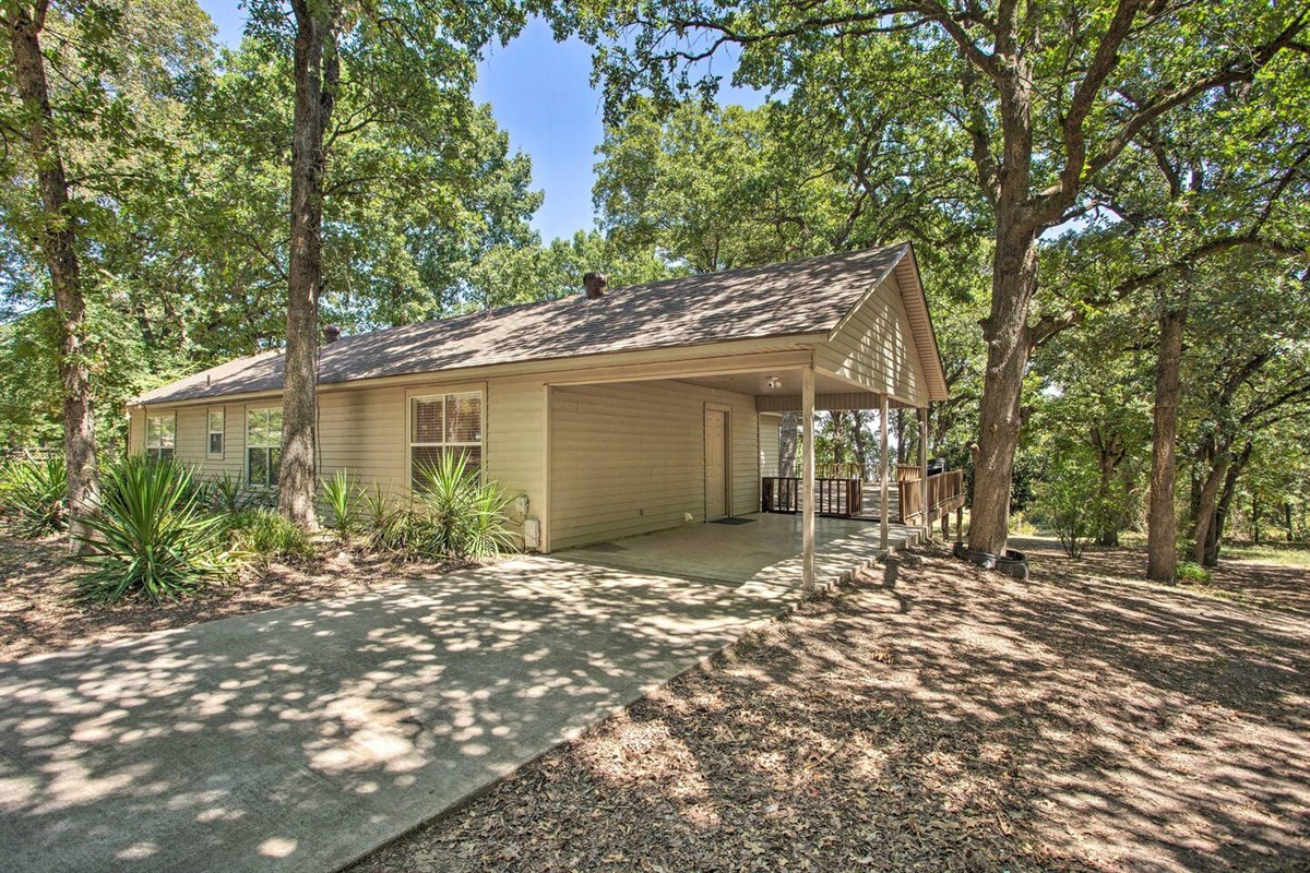 Driveway with main entrance at carport.