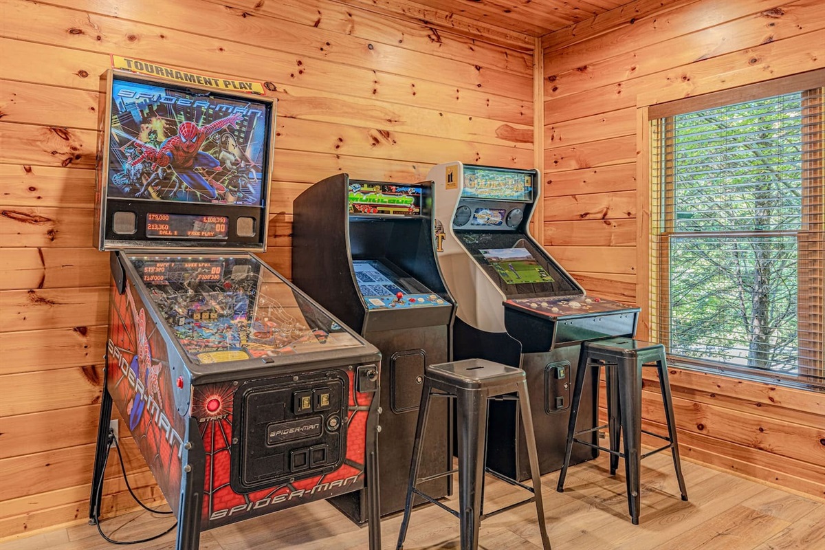 Full arcade game room with pinball, arcade cabinets, pool table, and air hockey. Gatlinburg cabin with game room &mdash; Rocky Top Sports World and Cal Ripken tournament lodging.
