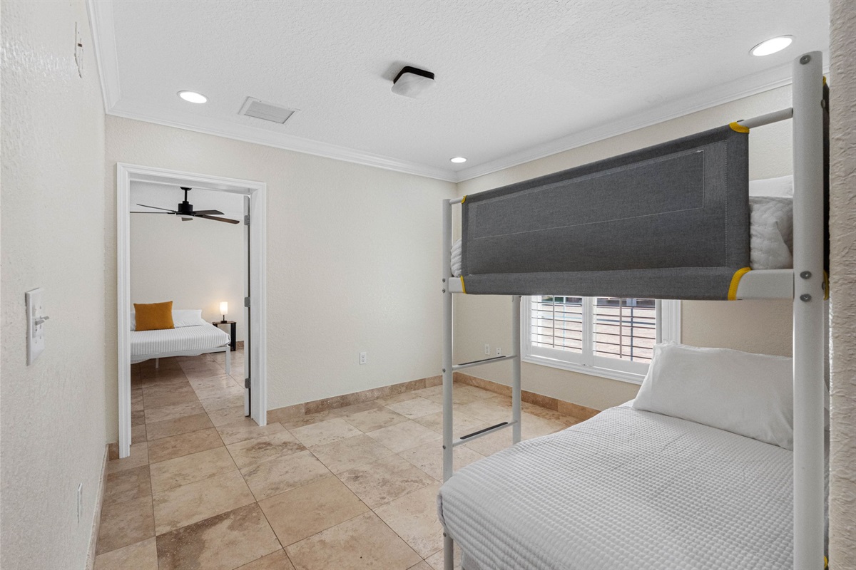 Featuring a sturdy bunk bed frame and fresh bedding, this room maximizes sleeping space without sacrificing style.