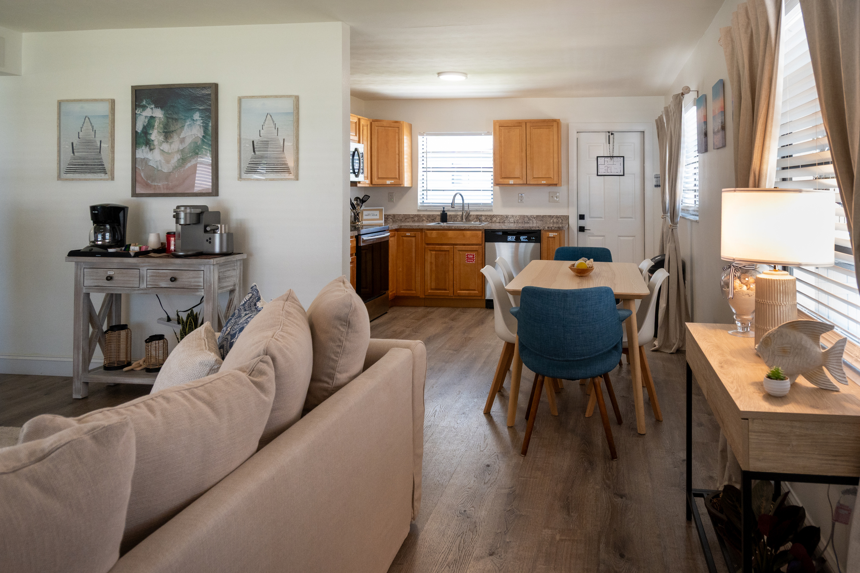 Open living space with sofas, dining for four and full kitchen – minutes from the sand
