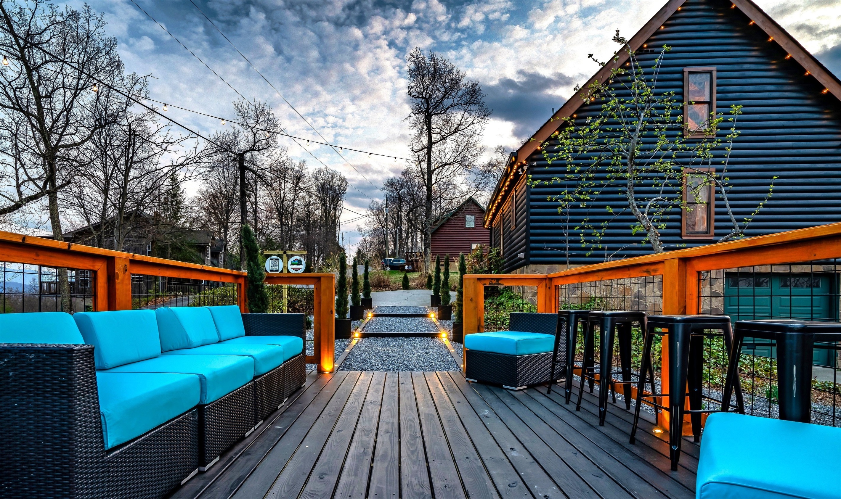 Scenic hangout deck (deck area #2) featuring sweeping mountain views, bar table and a colorful sunset, creating the perfect space for relaxation and memorable moments.