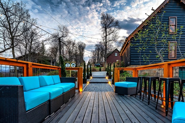 Scenic hangout deck (deck area #2) featuring sweeping mountain views, bar table and a colorful sunset, creating the perfect space for relaxation and memorable moments.