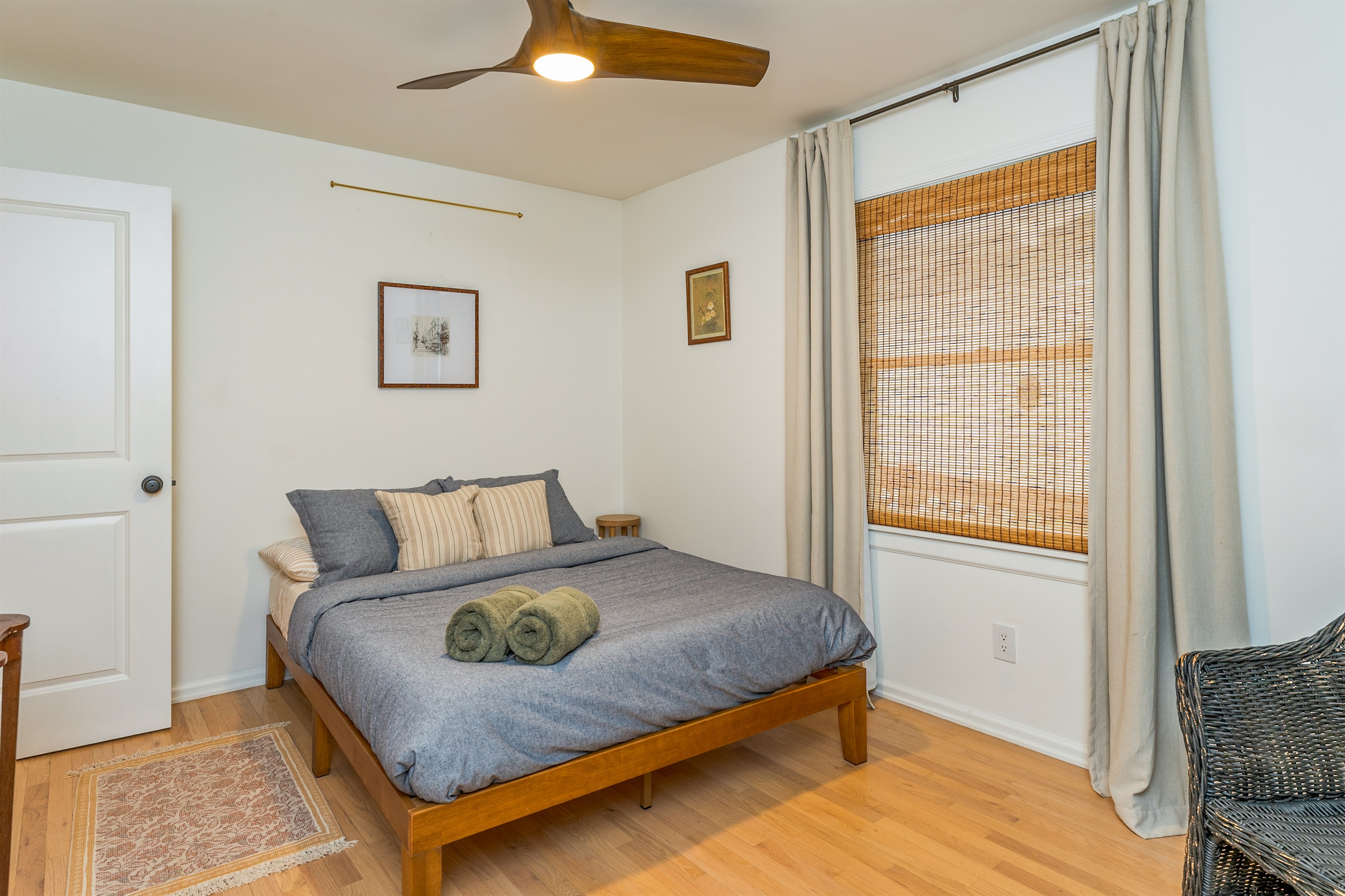 Relax in this serene bedroom with large windows, tranquil views, and plush bedding—your perfect escape after a day of Finger Lakes adventure