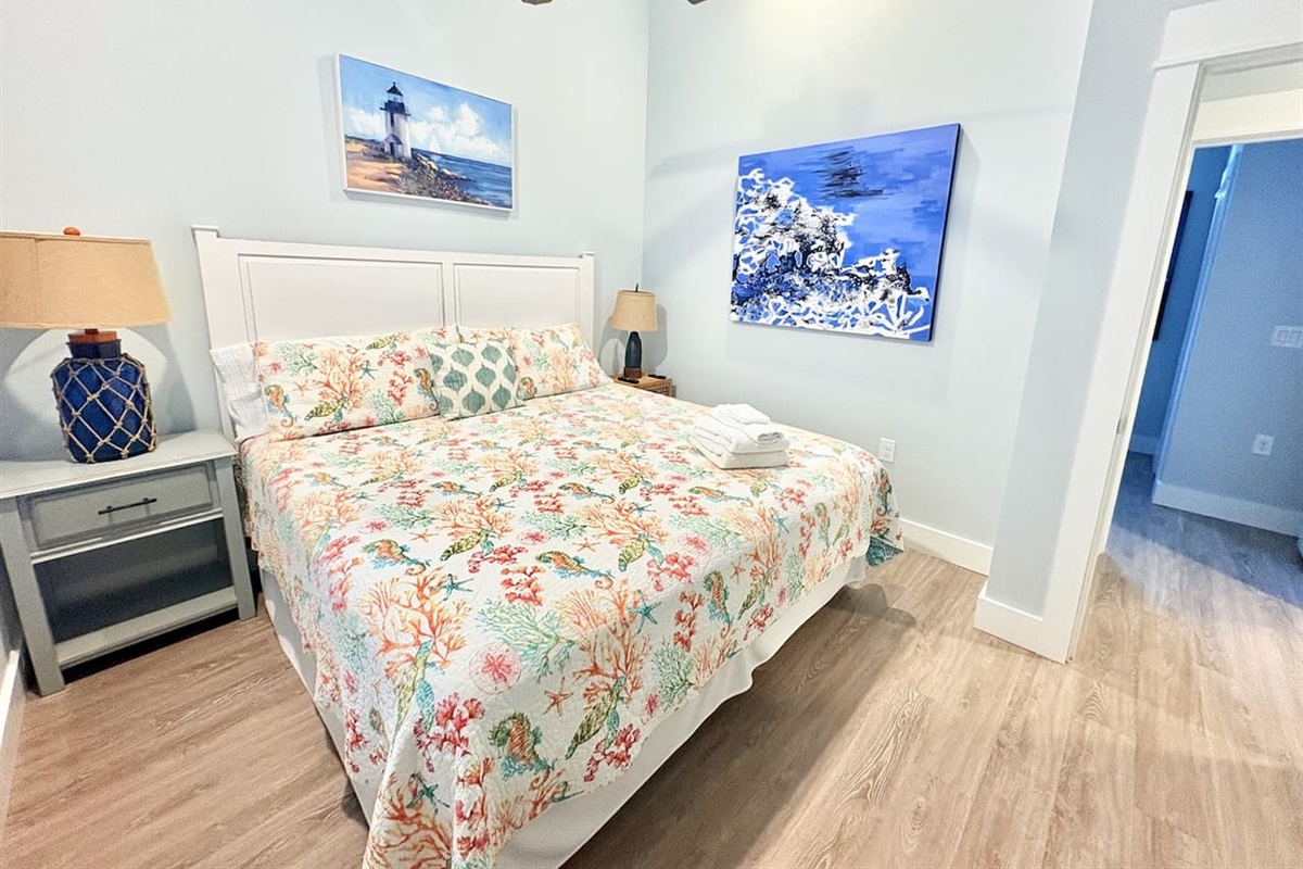 King Bedroom 2 with comfortable furnishings and artwork