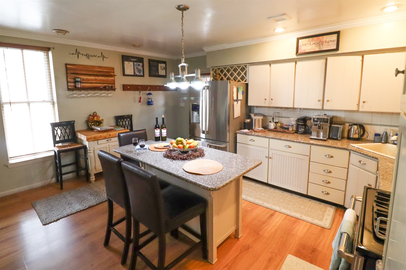 Fully equipped kitchen with espresso machine and cooking essentials.