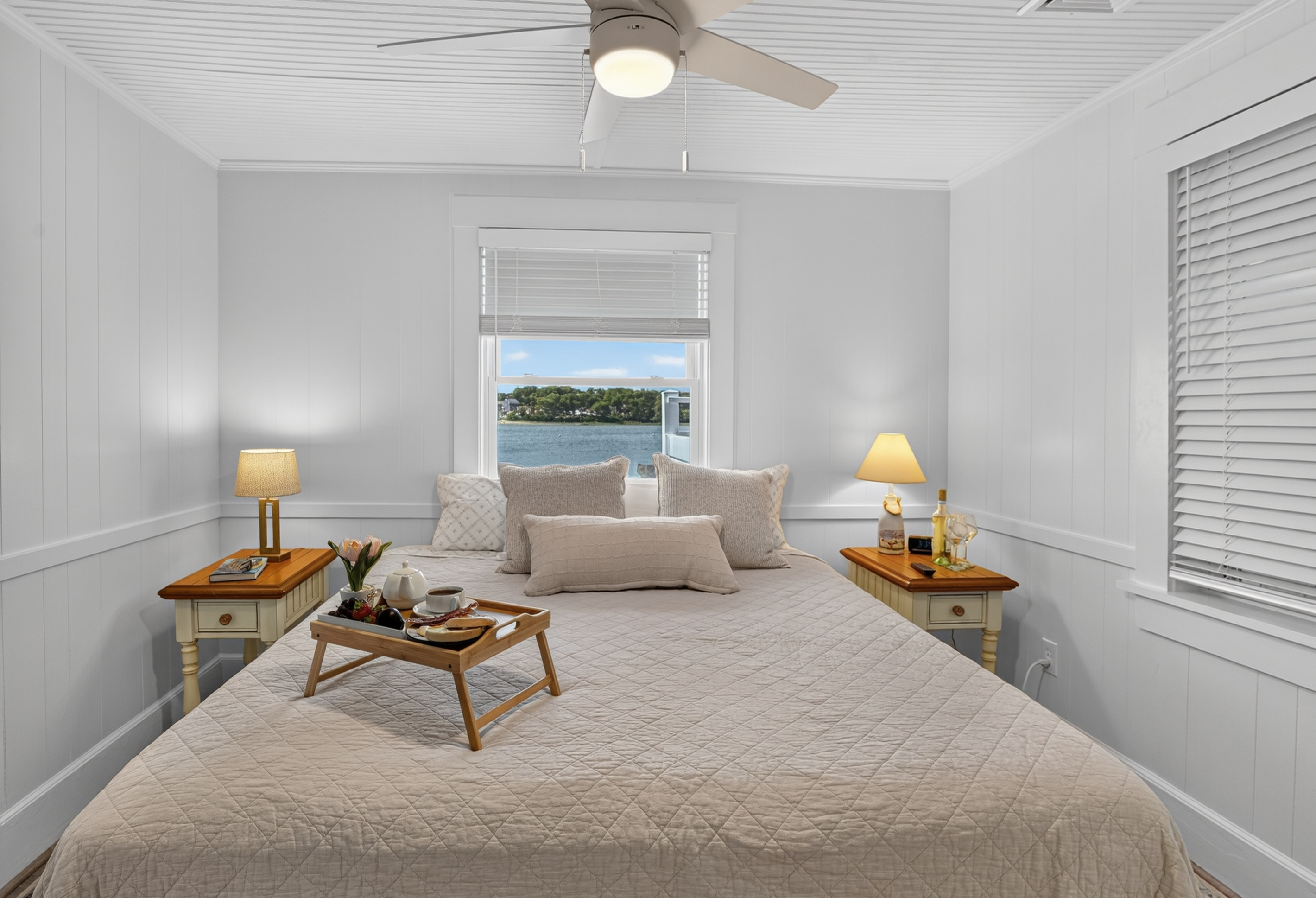 Spacious bedroom retreat with luxurious bedding and plenty of natural light for a restful night's sleep.