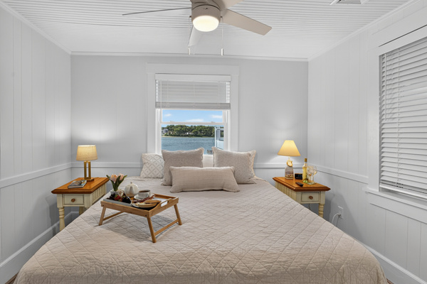 Spacious bedroom retreat with luxurious bedding and plenty of natural light for a restful night's sleep.