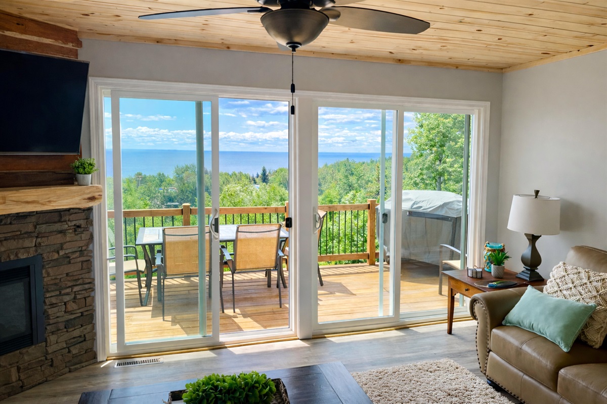 Uninterrupted Lake Superior views flow straight through the living room and out to the deck, where the grill and outdoor dining table overlook the water. Relax inside while staying fully connected to the lake, sunrise, and North Shore vibes included.