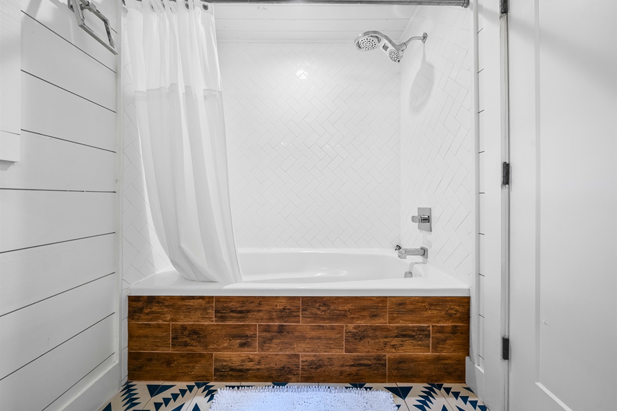 Bathroom with a tub-shower combo, ideal for families and soaking tired muscles.