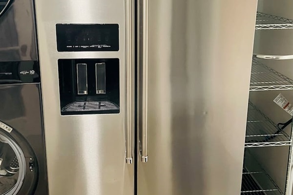 A full-sized side-by-side refrigerator and freezer keep everything organized and easily accessible for your stay.