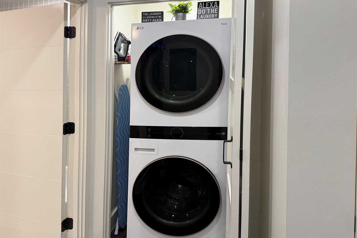 The laundry is located in the hall, just outside the bathroom.