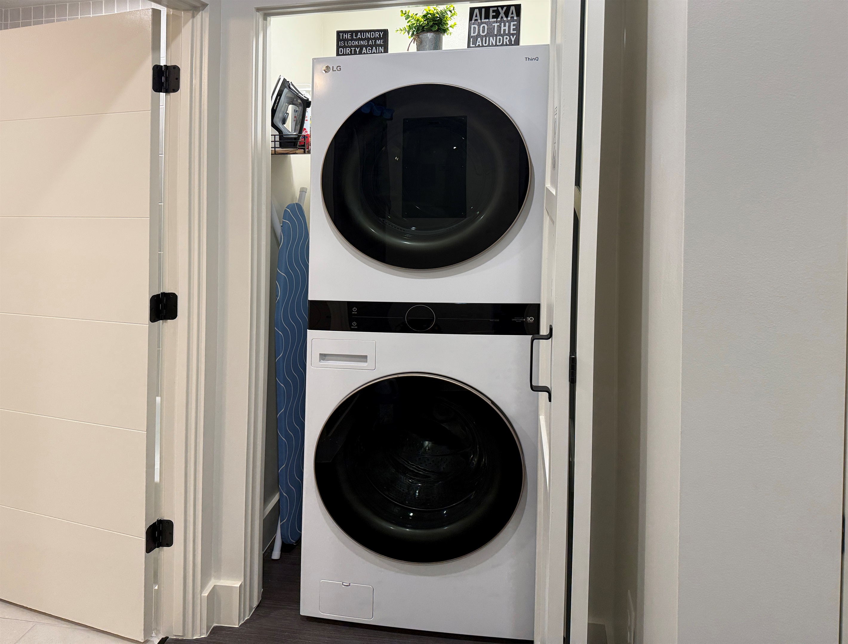 The laundry is located in the hall, just outside the bathroom.