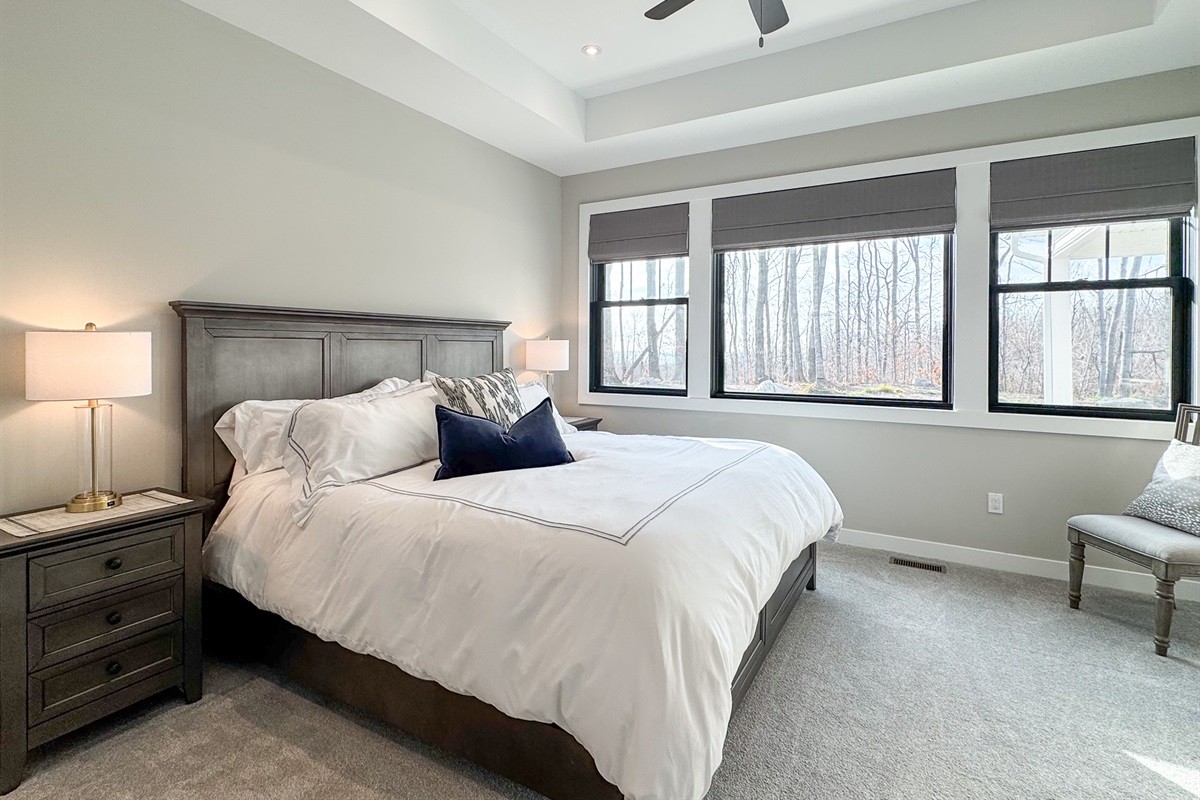 Primary bedroom with king bed and ceiling fan.