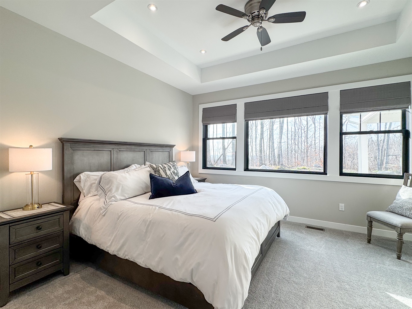 Primary bedroom with king bed and ceiling fan.