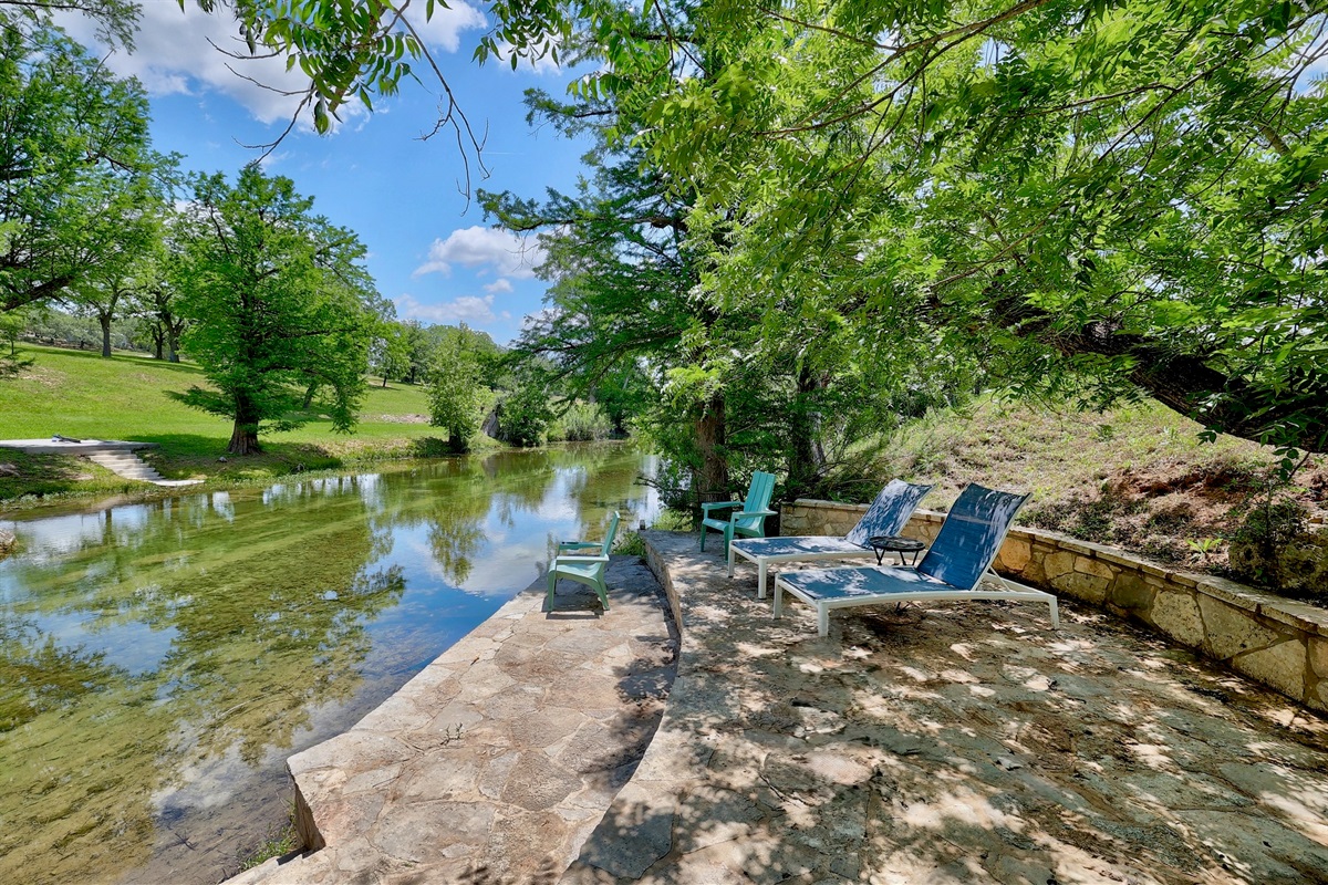 Riverfront rock deck for lounging by the water
