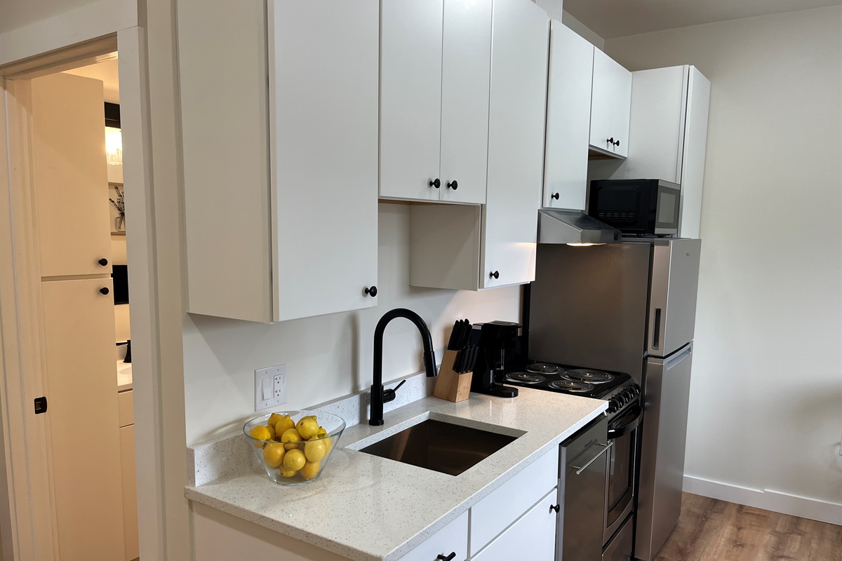 Kitchen area with bathroom beyond