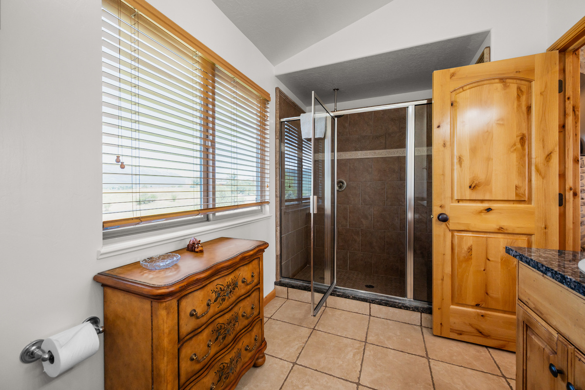 Experience unparalleled relaxation in our bathroom oasis, featuring stunning mountain vistas and vast shower..