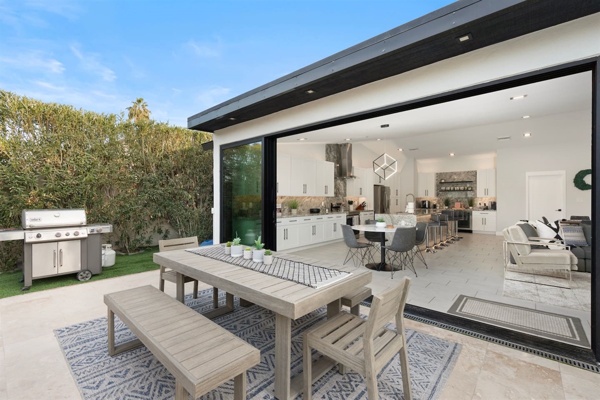 A Weber propane grill stands ready for barbecue nights, just steps away from the dining area and pool.
