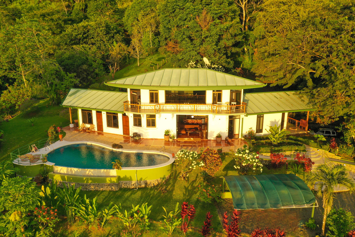 Evening aerial of Casa Infinity — villa and infinity pool at dusk