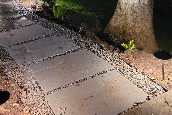 Landscape lights light the way to the hot tub patio, evening view