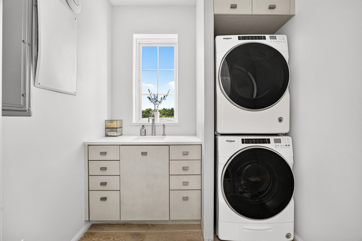 The laundry area offers a full sized washer and dryer, as well as a deep sink for soaking.