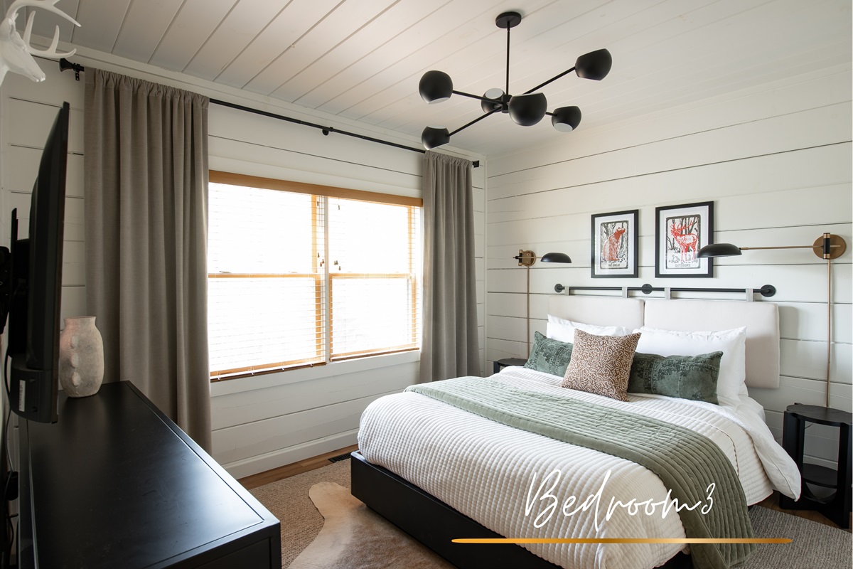 Bedroom 3 is light and bright, with a queen bed and a clean palette that keeps things airy and calm.