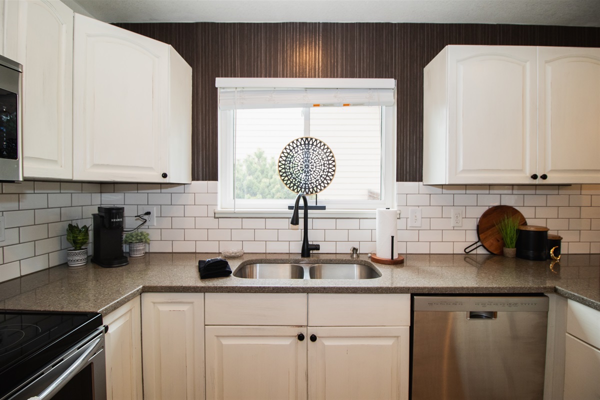 Warm kitchen stocked with coffee, flour, spices, cooking oil, and all of the essentials! All you need are the groceries.